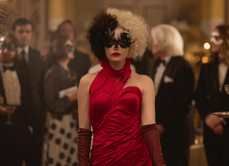 Cruella, personagem do filme de mesmo nome, em cena, com vestido vermelho.